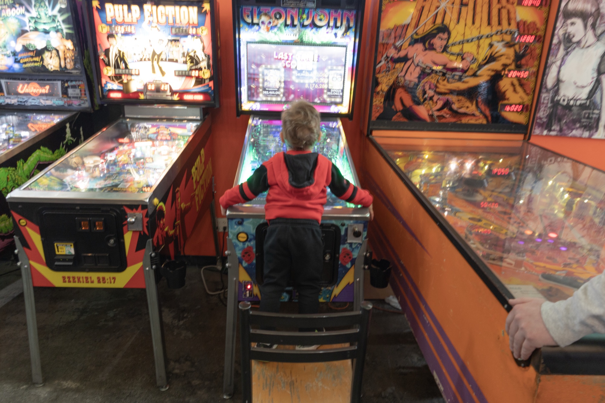 A young player at a pinball machine